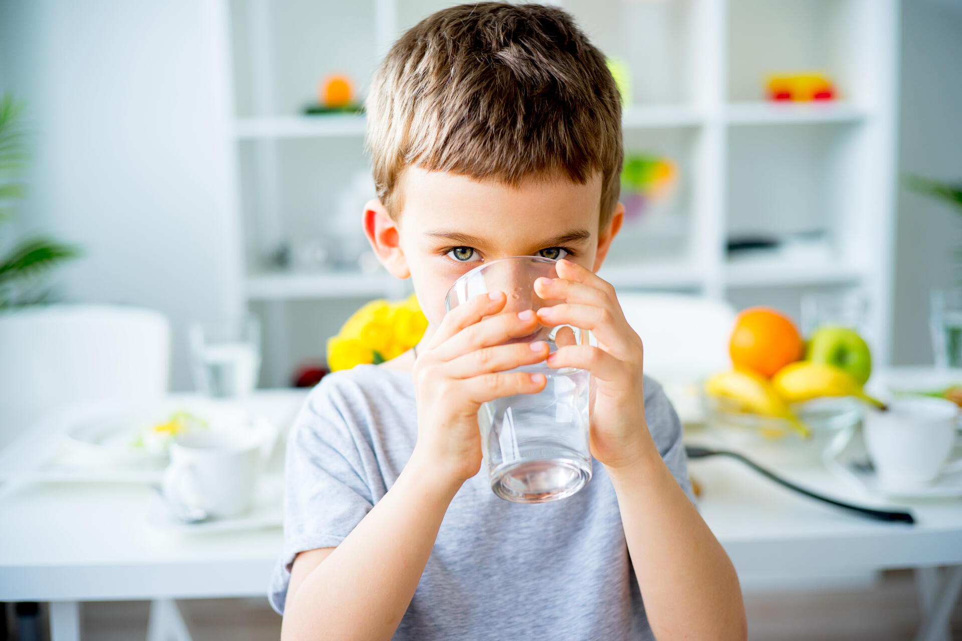 Young boy drinking glass of water